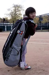 Ultimate Tennis Equipment List - little girl with a tennis bag