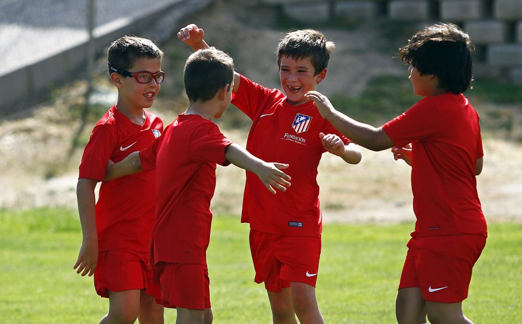 Youth soccer players engage in physical play