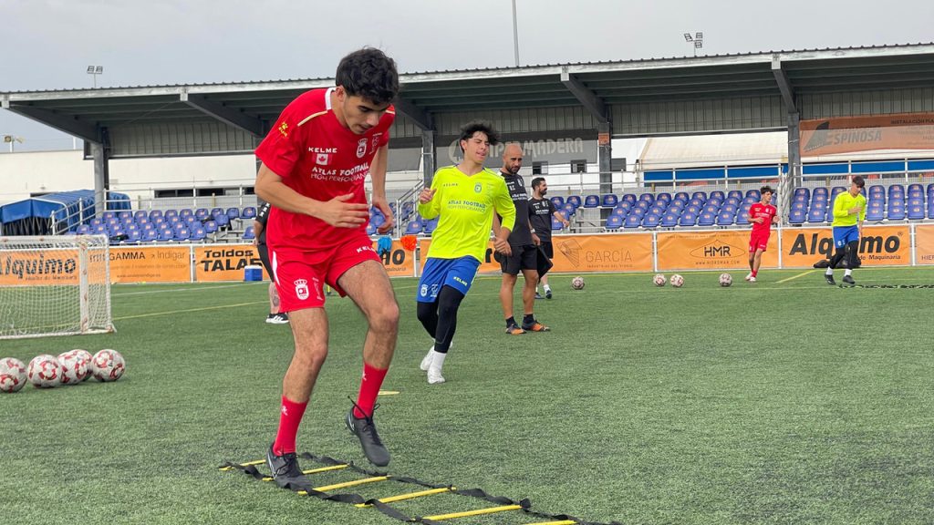 Players at a football trial in front of scouts from professional clubs
